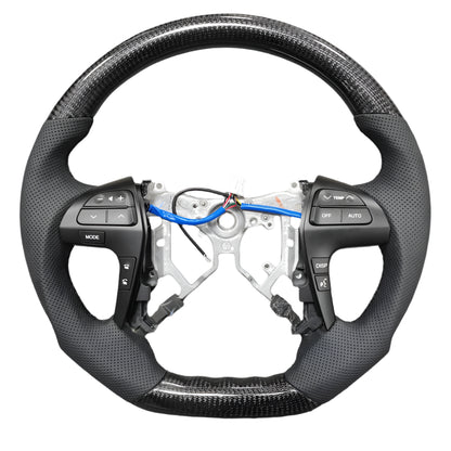 Steering wheel with wiring and components on a gray surface