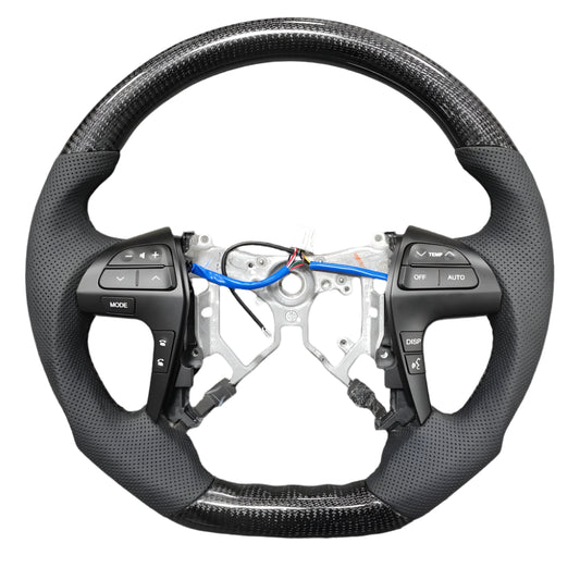 Steering wheel with wiring and components on a gray surface